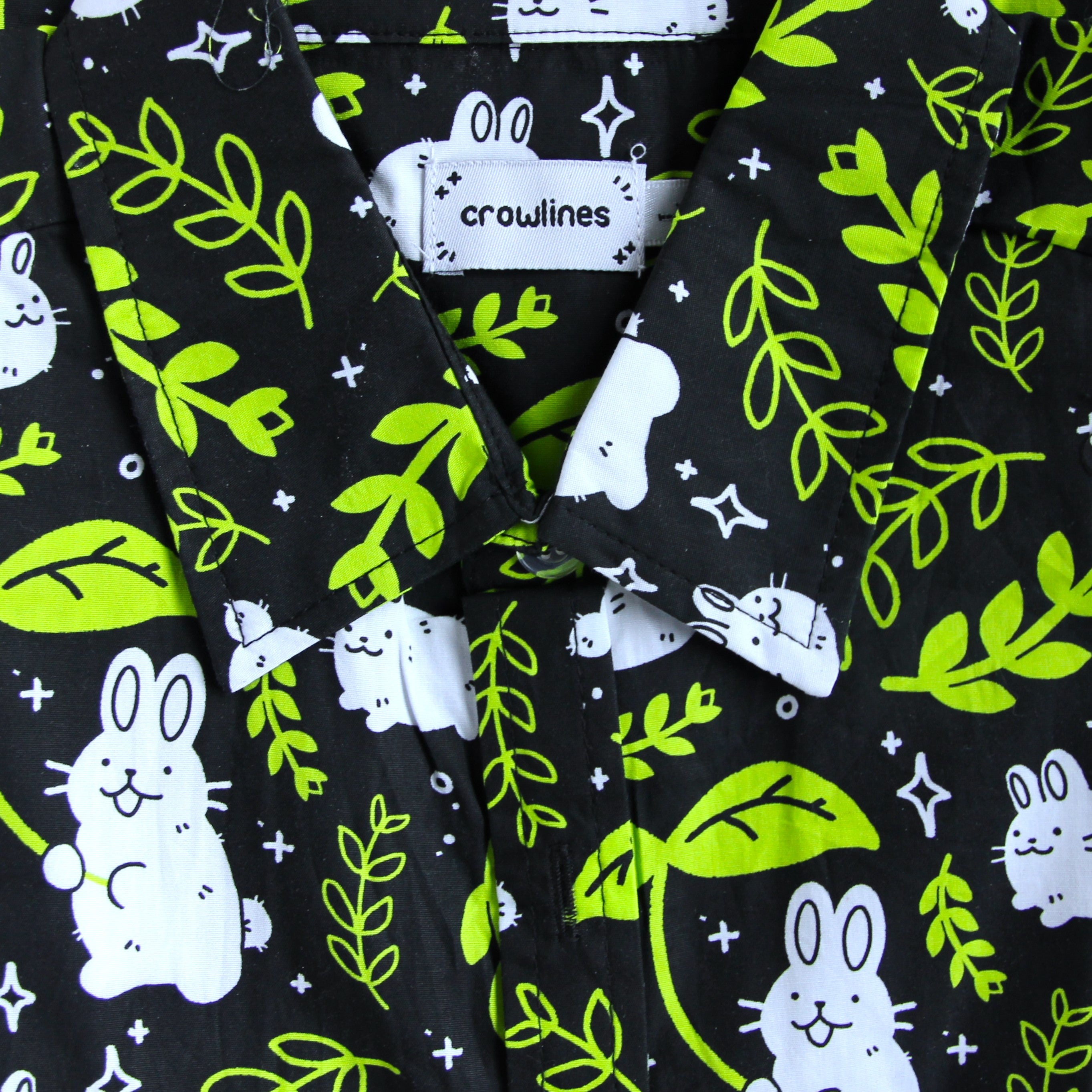 Black button up shirt patterned with rabbits and leaves
