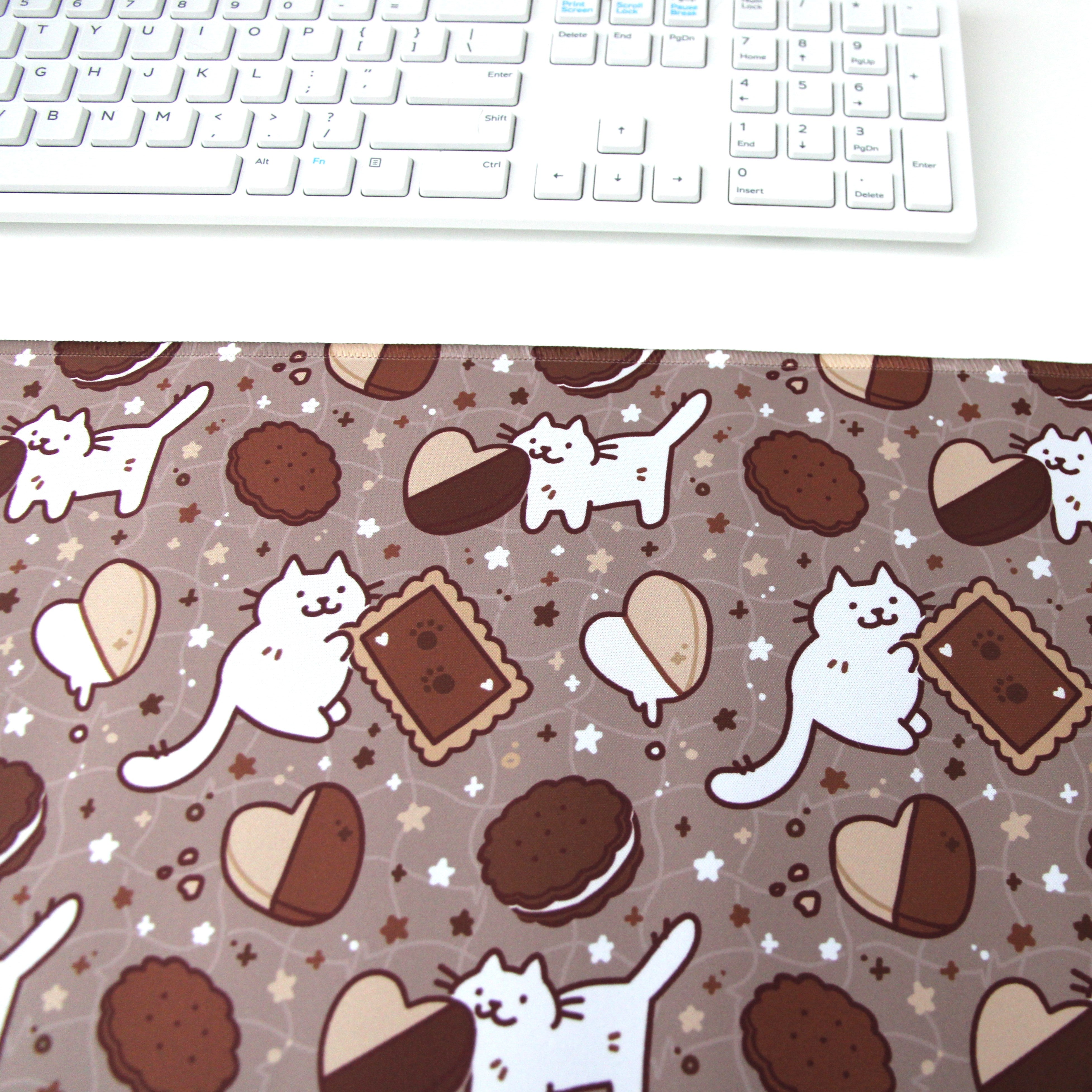 Brown desk mat patterned with cats and cookies