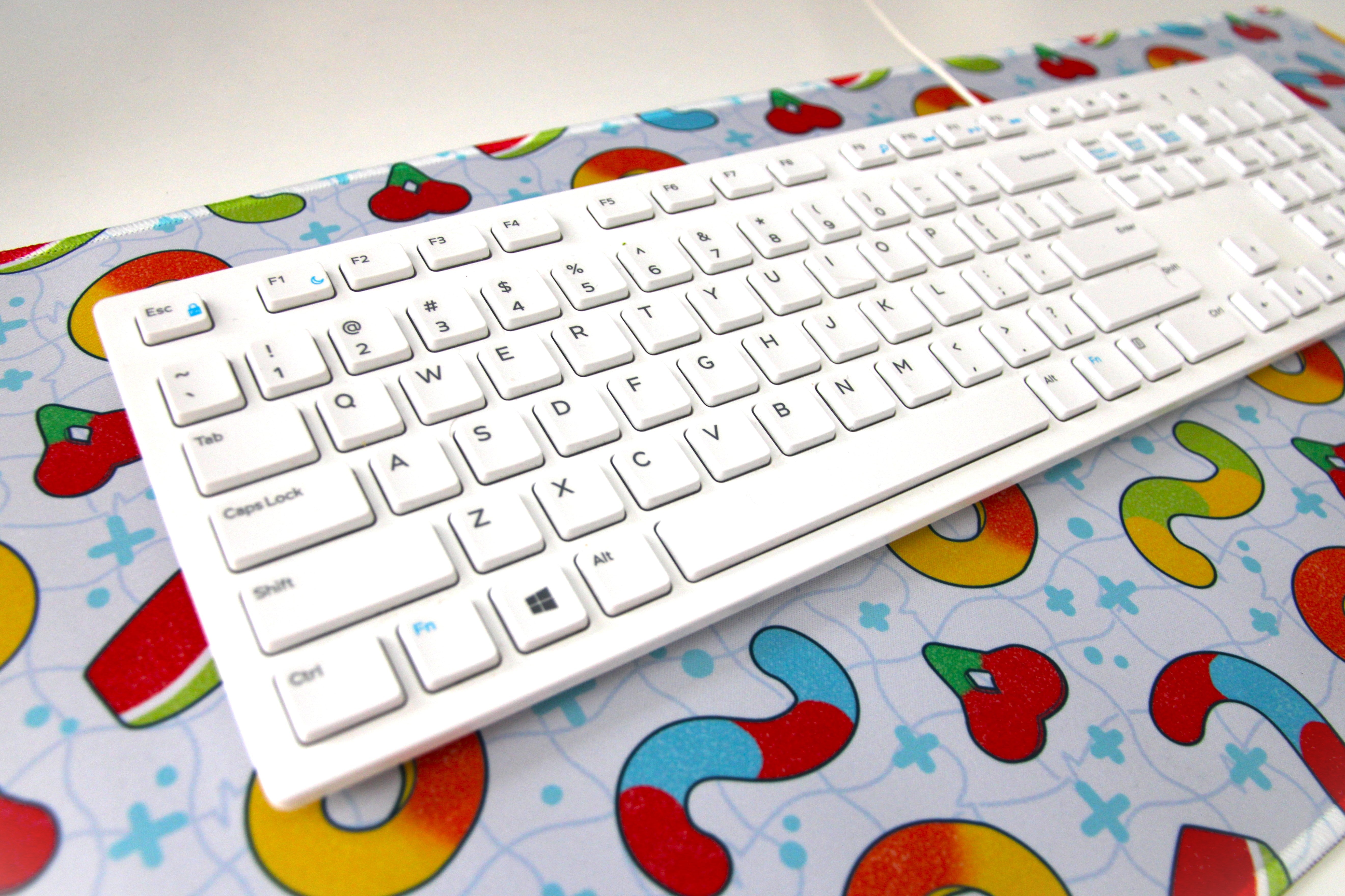 Light blue desk mat patterned with gummy candies