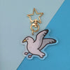 keychain of a seagull with its wings outstretched as if taking off or landing