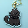 keychain of a black cat wearing a spiked collar