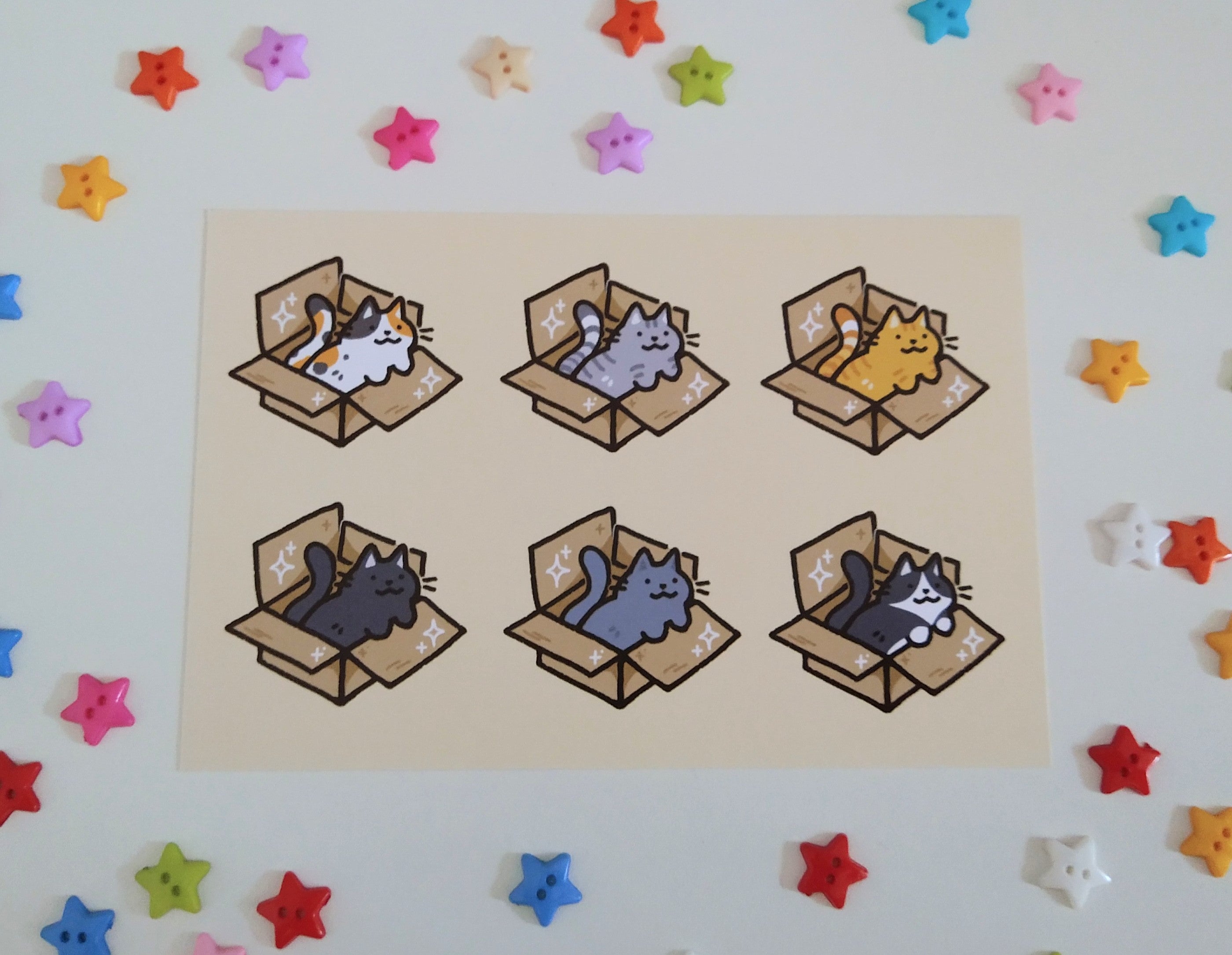 postcard mini print of six cats in cardboard boxes drawn in a kawaii style