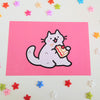 postcard mini print of a cat eating a slice of strawberry shortcake with crumbs on the side of its mouth, drawn in a kawaii style
