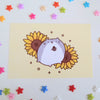 postcard mini print of a cute hamster holding a sunflower seed, with sunflowers in the background