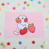 postcard mini print of a white cat holding strawberries with a pink background, drawn in a cute style