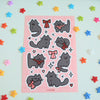 sticker sheet of cute black cats wearing red and pink ribbons