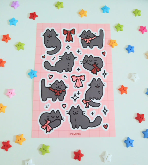 sticker sheet of cute black cats wearing red and pink ribbons
