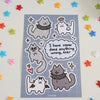 sticker sheet of cats dressed with angel halo and wings and devil horns and wings, some with spiked collars. speech bubble reads "I have never done anything wrong, ever"