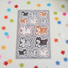 sticker sheet featuring black, gray, red, and white huskies drawn in a cute style