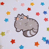 sticker of a gray tabby cat drawn in a cute style