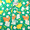 green button up shirt patterned with dogs and white flowers (alyssum) by crowlines