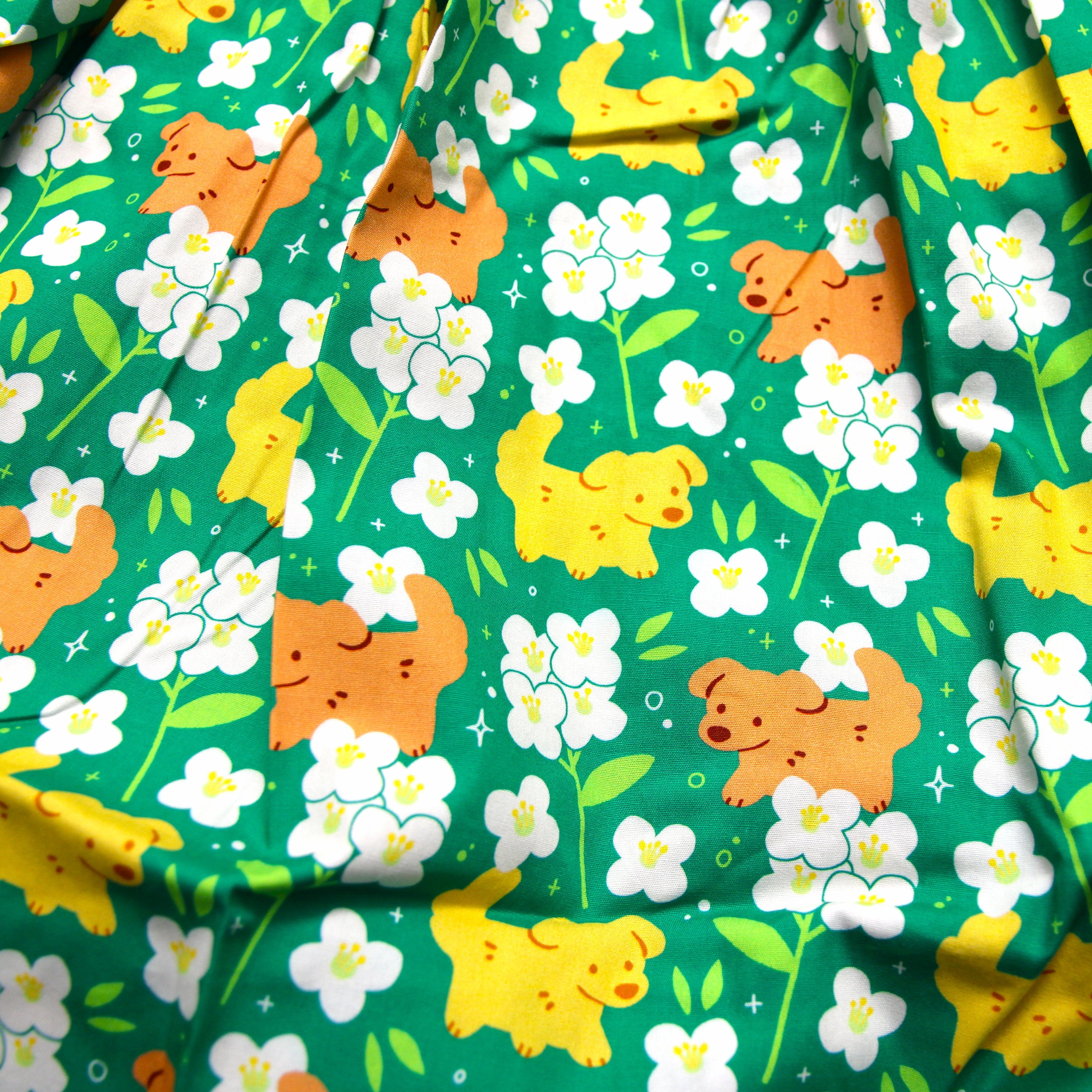 green skirt patterned with dogs and white flowers (alyssum)