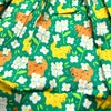 green skirt patterned with dogs and white flowers (alyssum)