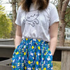 Blue skirt with pockets patterned with cats and lemons