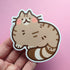Sticker of a brown tabby cat drawn in a kawaii style with round blushing cheeks
