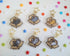 six different keychains featuring cats sitting in cardboard boxes