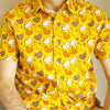 yellow button up shirt patterned with chickens and stars, worn by a model