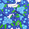 blue button up shirt patterned with white cats and forget me not flowers