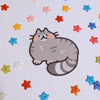 sticker of a gray tabby cat drawn in a cute style