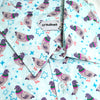 light blue button up shirt patterned with pigeons and sparkles
