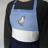 Color block apron with blue, white, and navy cotton. Embroidered with cute seagull with its mouth open