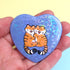 blue heart-shaped pinback button with two cute tigers hugging each other, layered with a holographic heart film