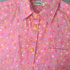 Pink button up shirt patterned with stars and sprinkles. The sprinkles are pink, white, yellow, and light blue. The shirt has yellow star-shaped buttons.