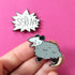 Two hard enamel pins. One is a pointy speech bubble "SCREAM." The other is a opossum with its mouth open, showing pointy teeth, as if screaming